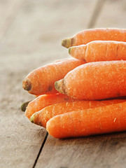 Carrot over wooden background close up