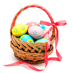 Colorful handmade easter eggs in the basket isolated