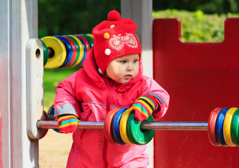 little girl playing with abacus on playground