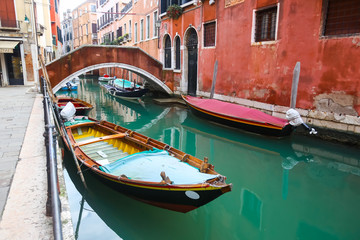 Fototapeta na wymiar Gondolas parked in water canal