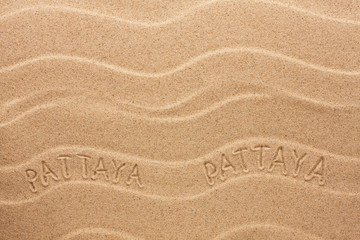 Pattaya inscription on the wavy sand