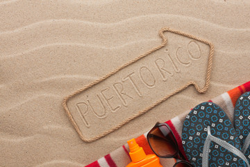 Puerto Rico  pointer and beach accessories lying on the sand