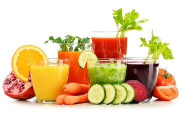 Glasses with fresh organic vegetable and fruit juices on white