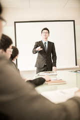 businessman giving a presentation to his colleagues