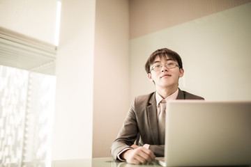 Young handsome man using laptop in his office