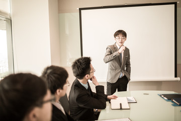 businessman giving a presentation to his colleagues