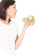 Pretty girl eating fresh vegetable salad