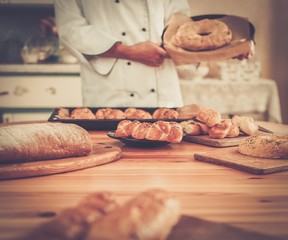 Cook hands holding homemade baked goods