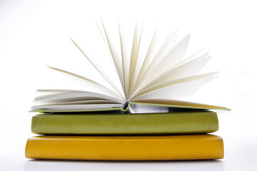 A stack of colorful books, open book. Back to school