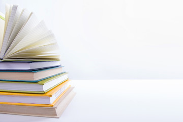 A stack of colorful books, open book. Back to school