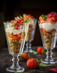 layered dessert in a glass with strawberry cream biscuits