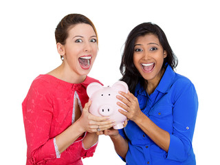 smiling laughing business women holding piggy bank 