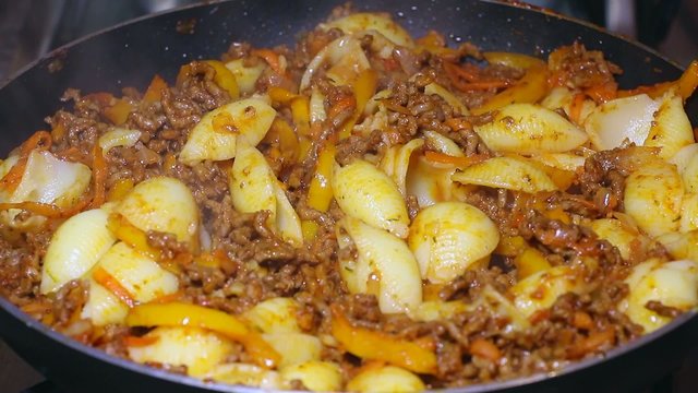 Minced meat with pasta and vegetables on a pan 