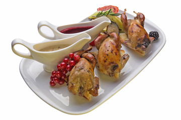 Roasted quail with vegetables on white background
