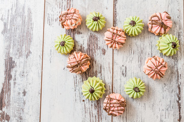 Assortment of colorful cookies on White Wooden Background	
