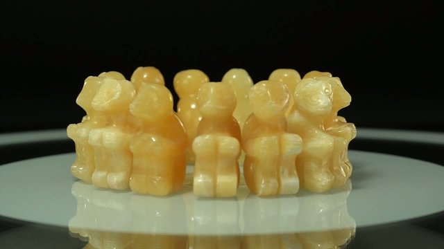 Carved aragonite monkeys rotating