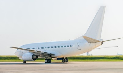 Fototapeta na wymiar White plane in airport from behind