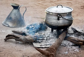 Gordijnen Cooking corn cereal in contrule on fire in the village © okyela