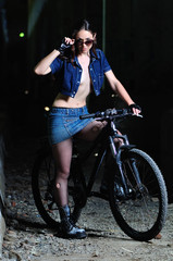 Fototapeta na wymiar The girl on a bicycle in an abandoned room
