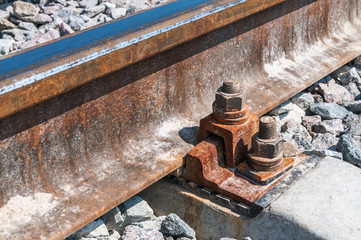 Railroad nut and bolt on background of gravel