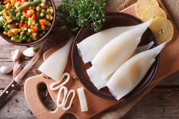 Foto op Plexiglas Preparation of raw squid and ingredients horizontal top view © FomaA
