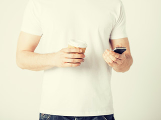 man with smartphone and coffee