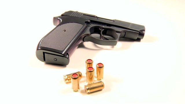 Semi-automatic handgun with golden teargas cartridges