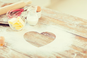 close up of heart of flour on wooden table at home