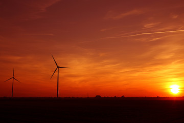 Obraz premium Windmills of the sunset in the background