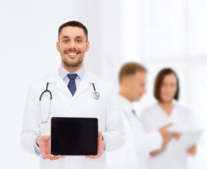 smiling male doctor with tablet pc