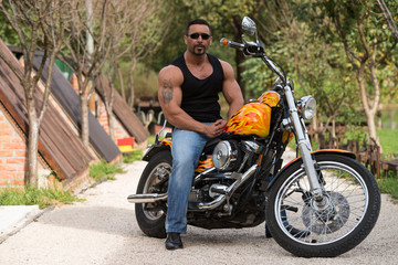 Fototapeta na wymiar Muscular Man And Motorcycle