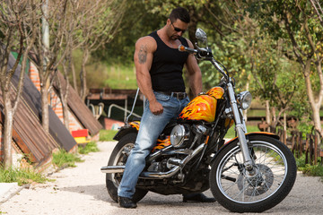 Obraz na płótnie Canvas Bodybuilder And Motorcycle