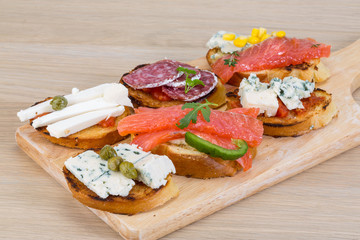 Tapas with cheese, salami and salmon
