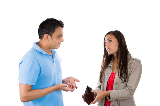 Woman showing upset man an empty wallet 