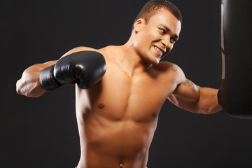 Fototapeta na wymiar Handsome boxer on the workout