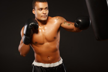 Fototapeta na wymiar Handsome boxer on the workout