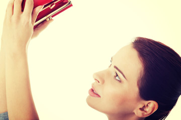 Beautiful woman showing her empty wallet.