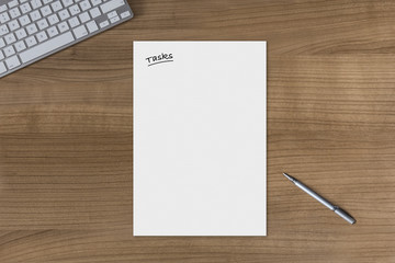 Blank sheet Tasks on a wooden table