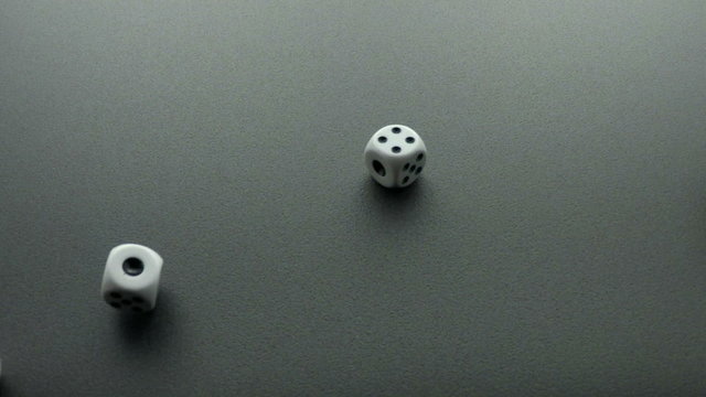 dice cast on black slow motion