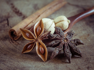 cinnamon sticks and star anise on rustic wood background