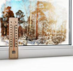 Thermometer on a frozen window and cold weather