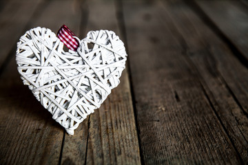 Fototapeta premium White heart on a wooden background.