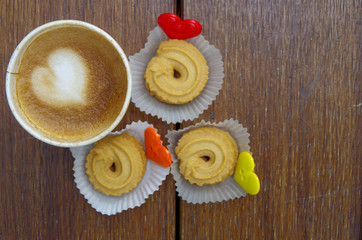 cup of coffee with cookie and buttons shape heart