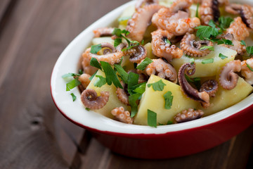 Octopus salad with potato and parsley, traditional italian dish
