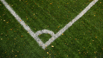 Corner white angle line of green short grass soccer field stadium