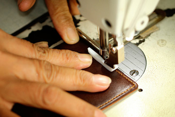 Tailor working on a sewing machine at textile factory
