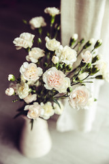 delicate bouquet of carnations in a vase vintage. romance
