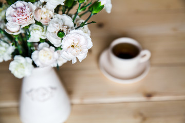 delicate bouquet of carnations in a vase on a vintage