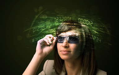 Business woman looking at high tech number calculations
