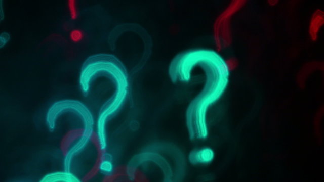 Question marks. Out of focus lights background. 4K UHD footage.